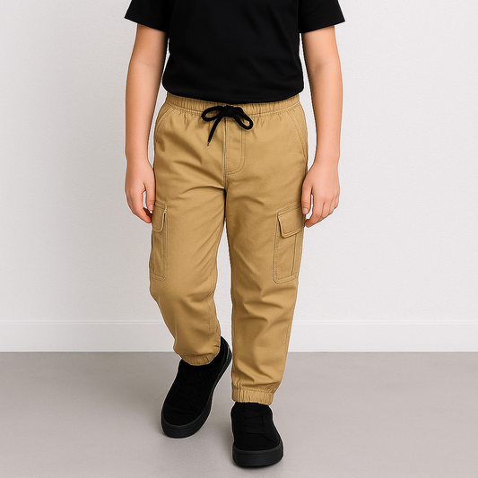 Child wearing a black t-shirt and beige cargo pants on a white background